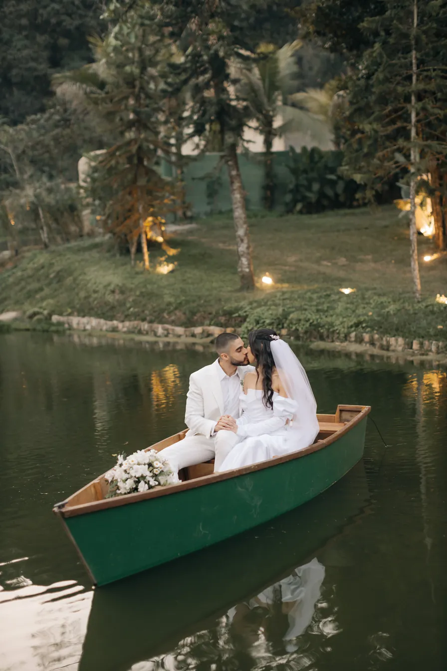 Noivos se beijando num barco no lago